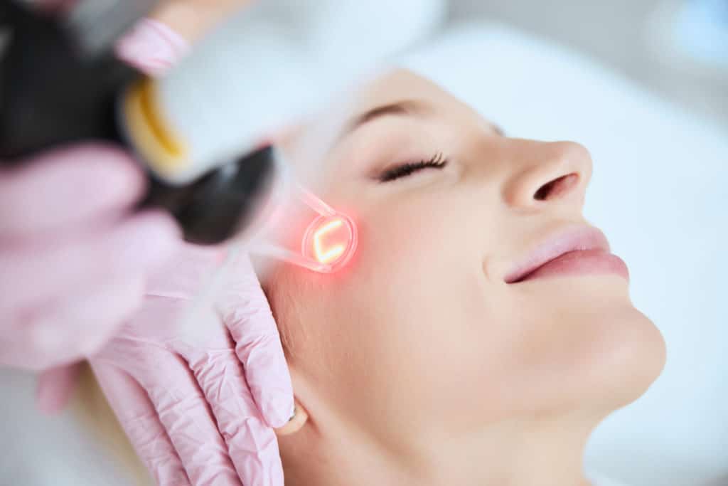 A woman undergoing a laser treatment for aesthetic purposes.